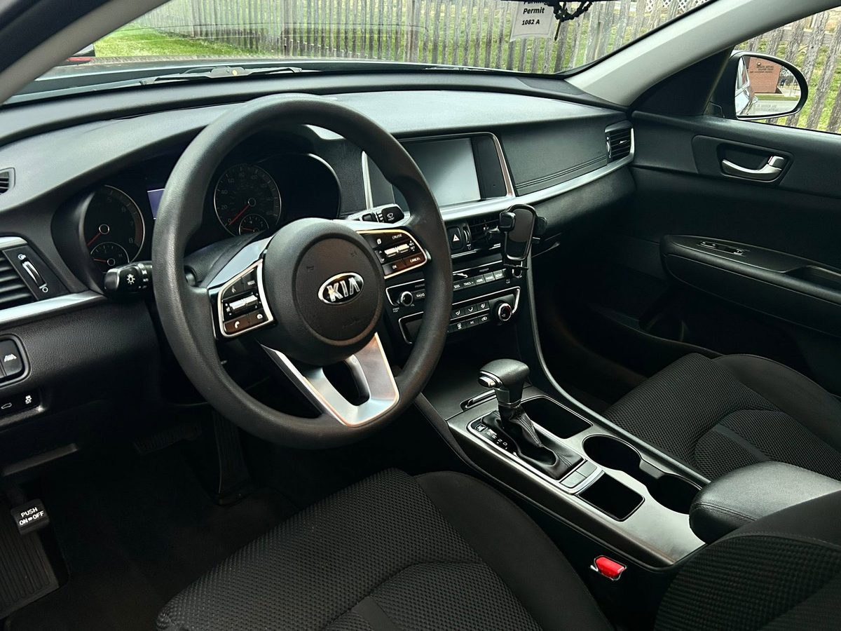 Kia Optima front interior after detailing, dash, console, and seats clean